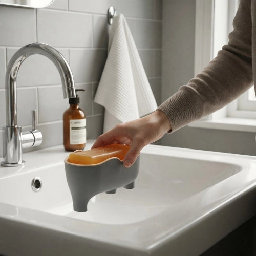 Porte-savon gris sur pieds avec savon et main tendue