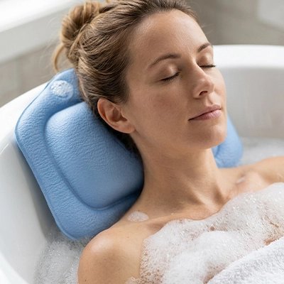 Femme profitant d’un bain avec un coussin pour la baignoire