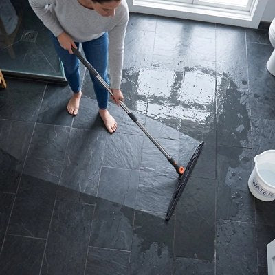 ​Lame en caoutchouc de la raclette éliminant l’eau sur carrelage