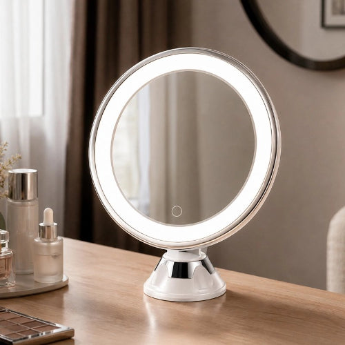 Miroir lumineux rond posé sur un meuble de salle de bain