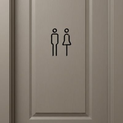 Panneau WC homme et femme fixé sur une porte grise