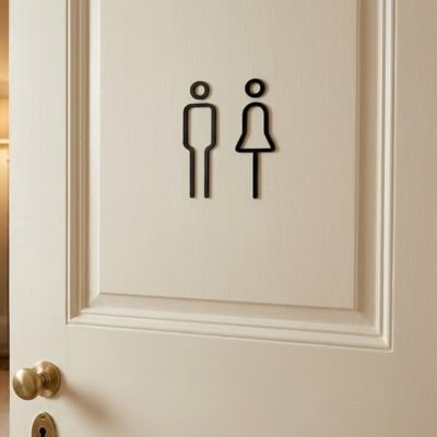 Pictogrammes homme et femme adhésifs sur porte de toilette beige