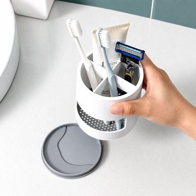 Porte-brosse à dents blanc et gris avec drainage intégré