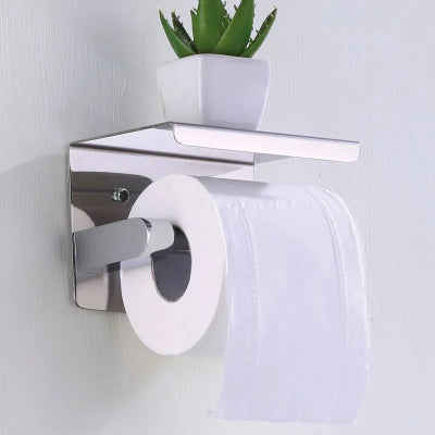 porte papier toilette argent sur mur blanc